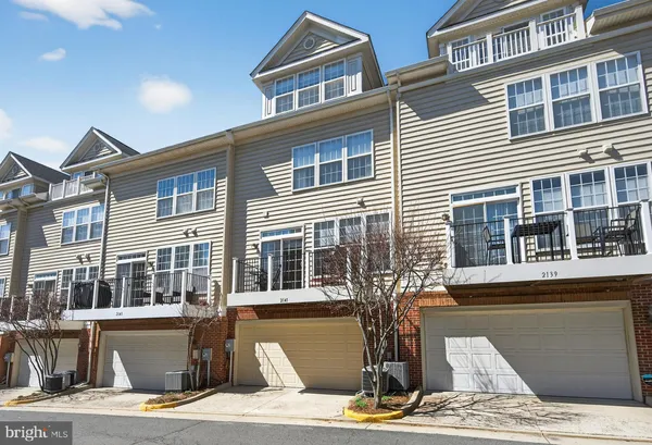 a front view of a house with a street