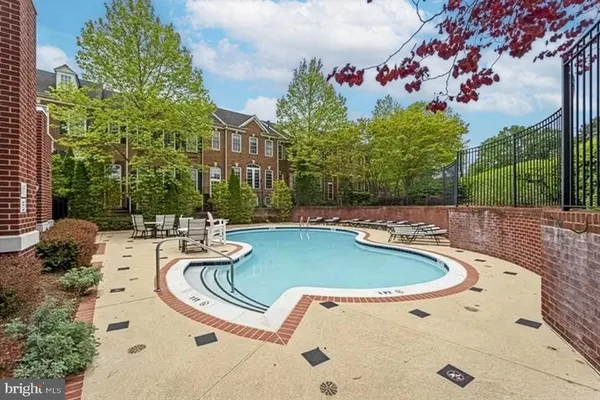 a view of a swimming pool with outdoor seating and plants