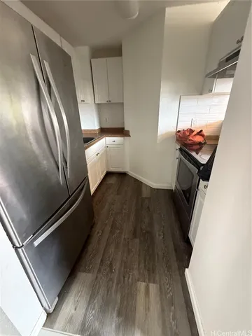 a view of a kitchen from a hallway