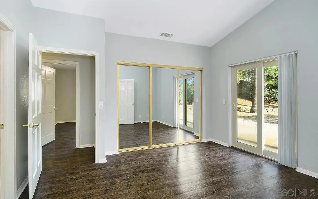 14525 Millards Ranch Lane Poway, CA 92064 - Photo 17 of 29 an empty room with wooden floor and windows