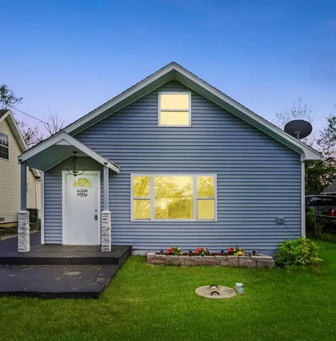 a view of an house with backyard space and garden