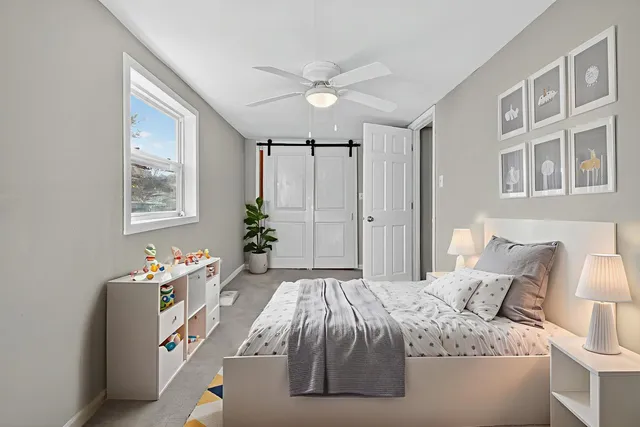 a bedroom with a bed and a chandelier