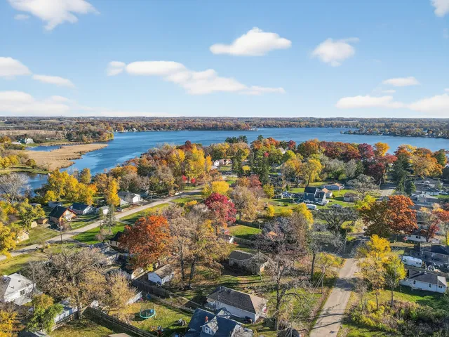 an aerial view of a houses with ocean view