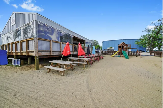 a view of a lake with a table and chairs