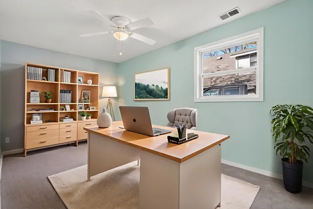 a work room with furniture and window