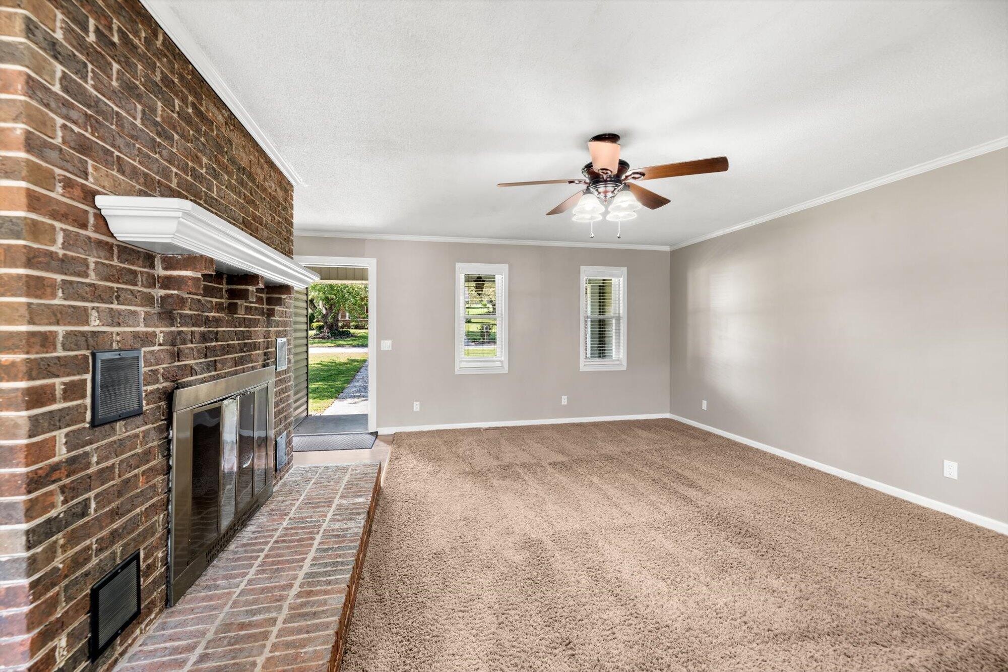 1302 Ridgeway Circle Athens, TN 37303 - Photo 3 of 17 a view of a livingroom with a fireplace a chandelier and windows