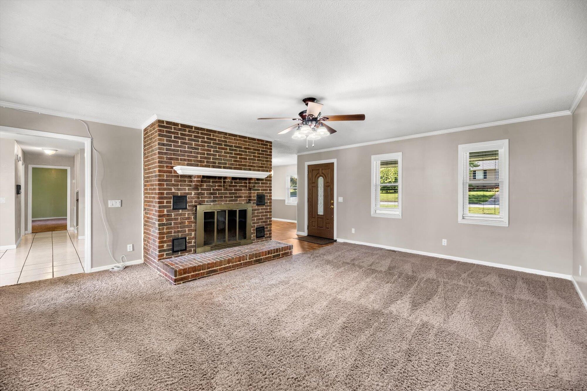 1302 Ridgeway Circle Athens, TN 37303 - Photo 4 of 17 a view of an empty room with a fireplace and a window