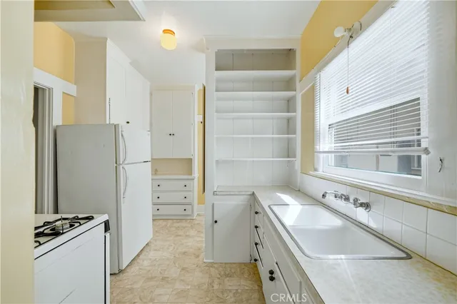 a kitchen with a sink stove and refrigerator