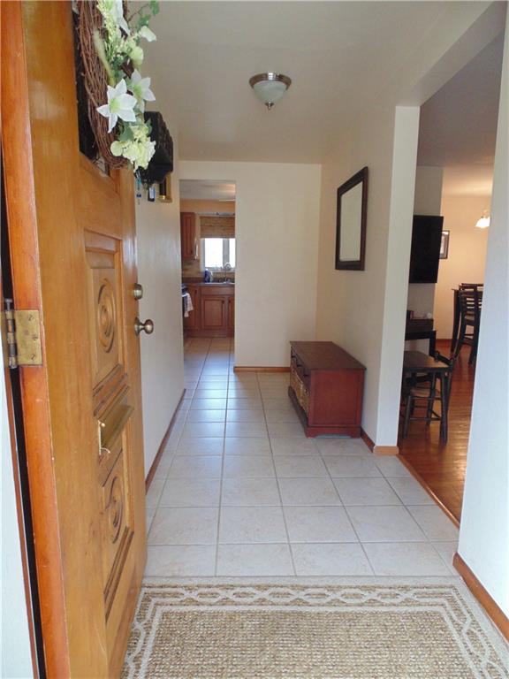 500 Walnut Street Springdale, PA 15144 - Photo 5 of 16 Large, inviting entry with double coat closet (behind door on left). Open concept living room and dining room through the doorway on right.