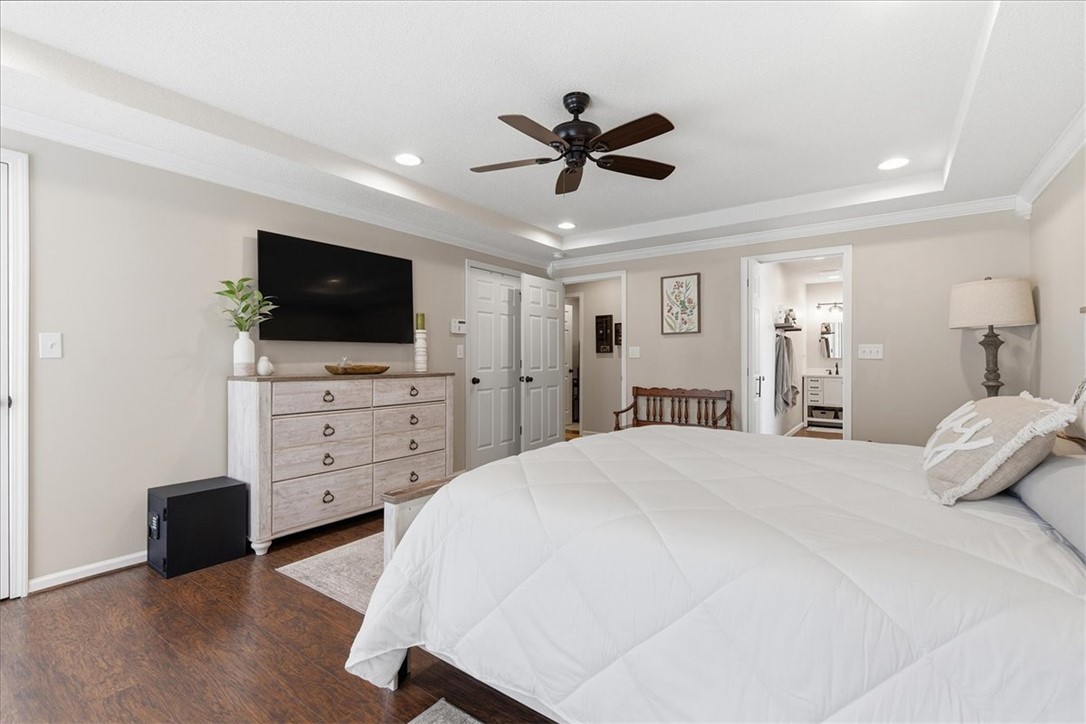 166 Amberwood Drive Anderson, SC 29621 - Photo 14 of 38 This primary bedroom offers ample space, warm wood flooring, and elegant crown molding for ultimate comfort.