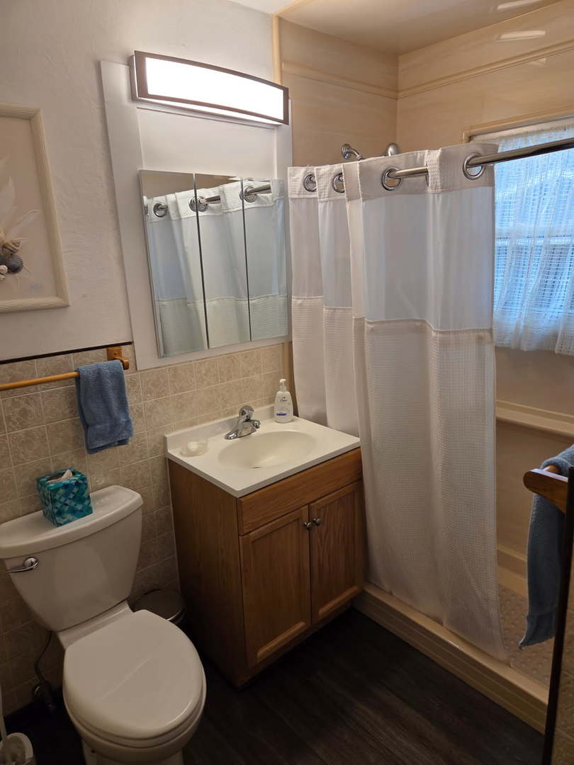 215 Brice Avenue Mundelein, IL 60060 - Photo 11 of 15 a bathroom with a sink toilet and shower