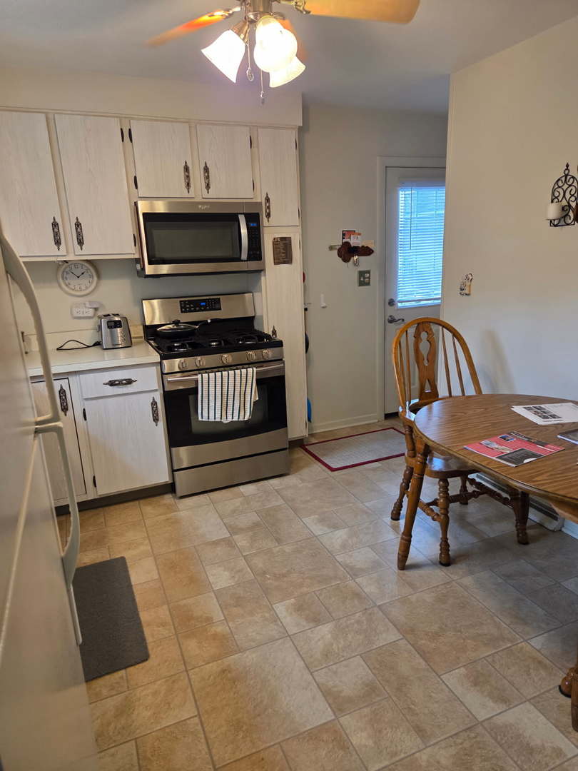 215 Brice Avenue Mundelein, IL 60060 - Photo 6 of 15 a kitchen with granite countertop a stove a sink and a microwave