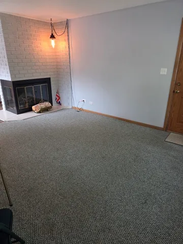 a view of empty room with fireplace