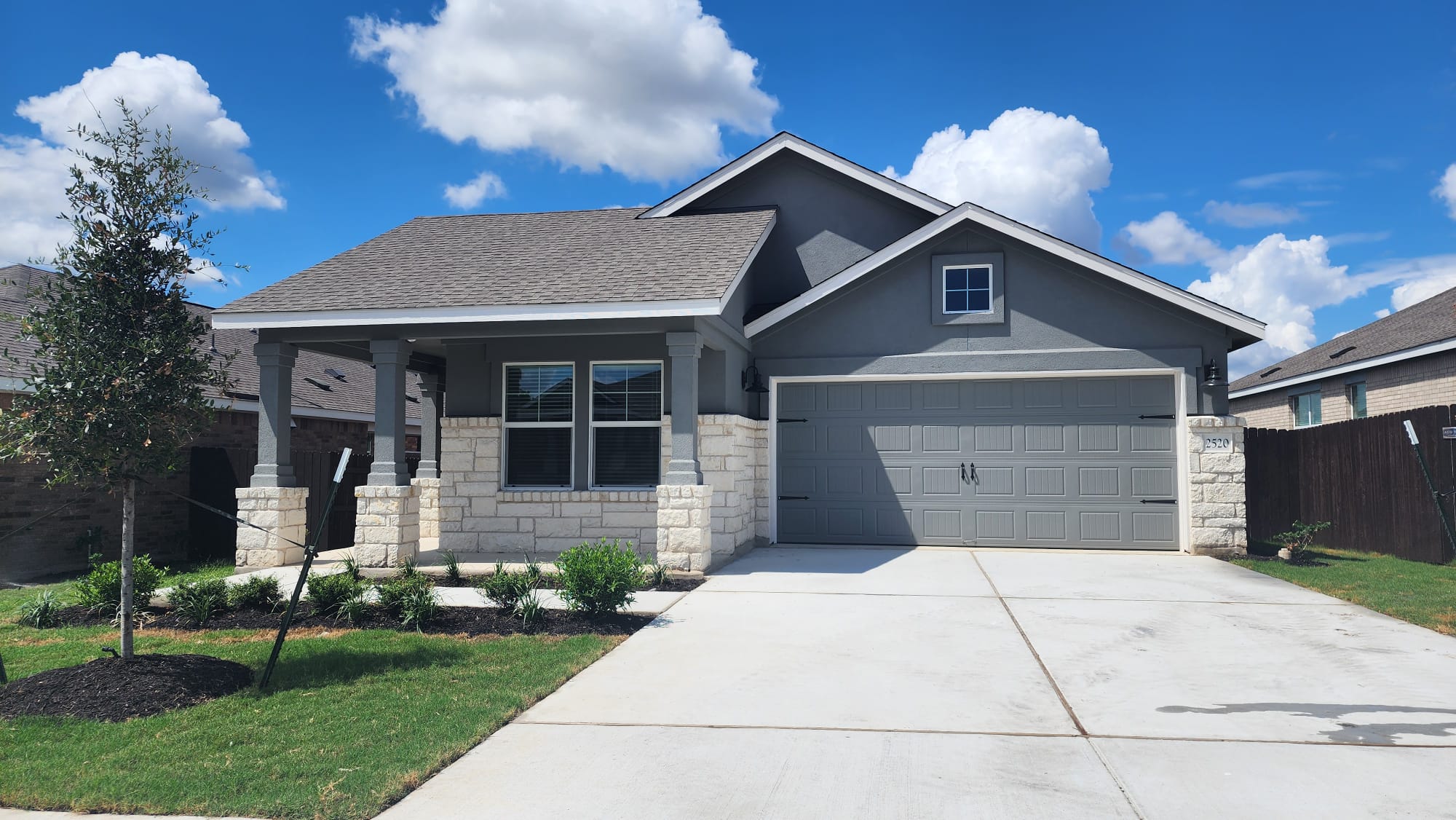 2520 Four Waters Loop Georgetown, TX 78628 - Photo 1 of 15 Craftsman house featuring stone siding, concrete driveway, an attached garage, and a porch