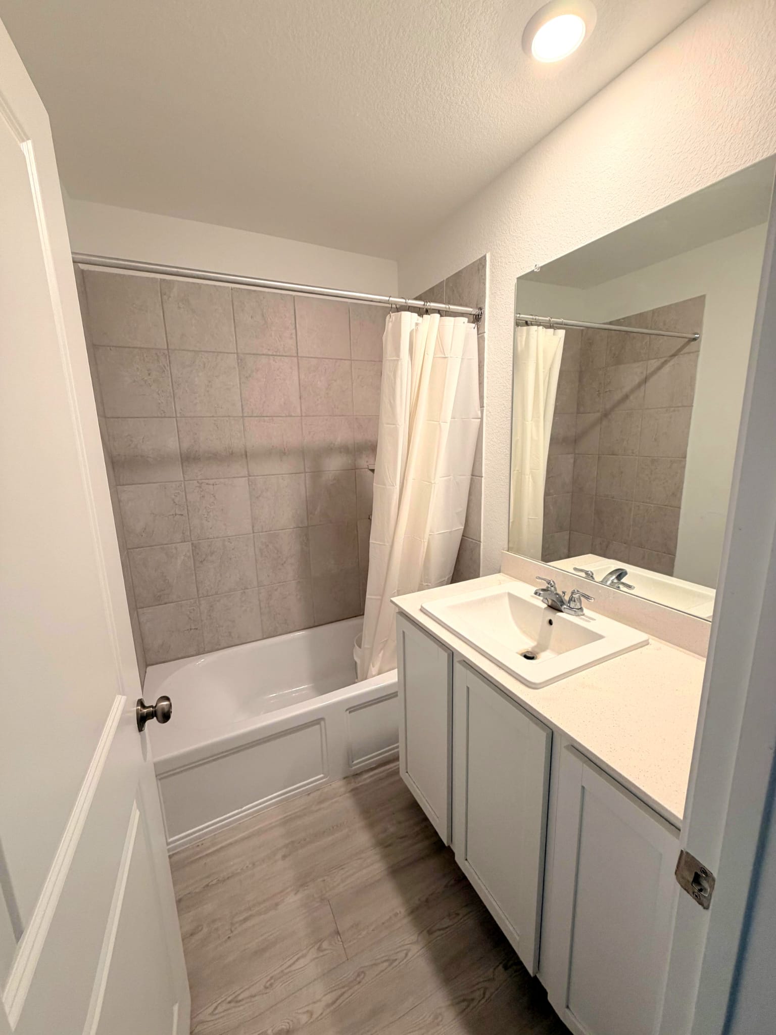 2520 Four Waters Loop Georgetown, TX 78628 - Photo 11 of 15 Full bath with vanity, shower / bath combo, light wood-style floors, and a textured ceiling