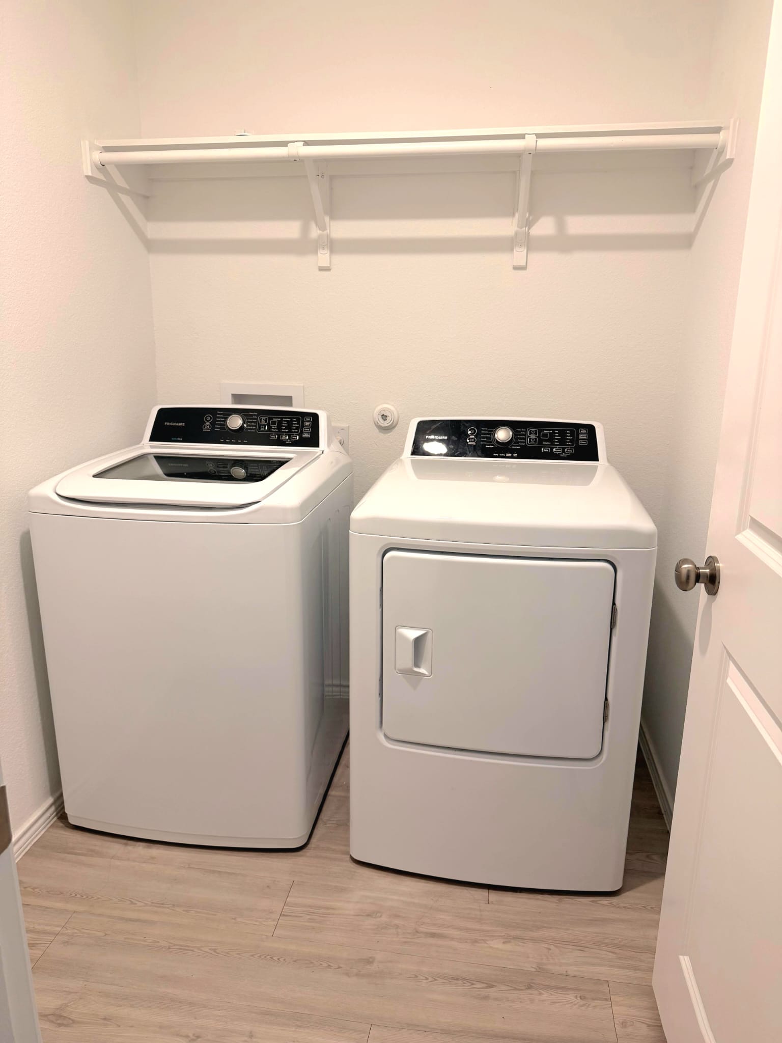 2520 Four Waters Loop Georgetown, TX 78628 - Photo 15 of 15 Laundry room featuring light wood finished floors and washing machine and clothes dryer