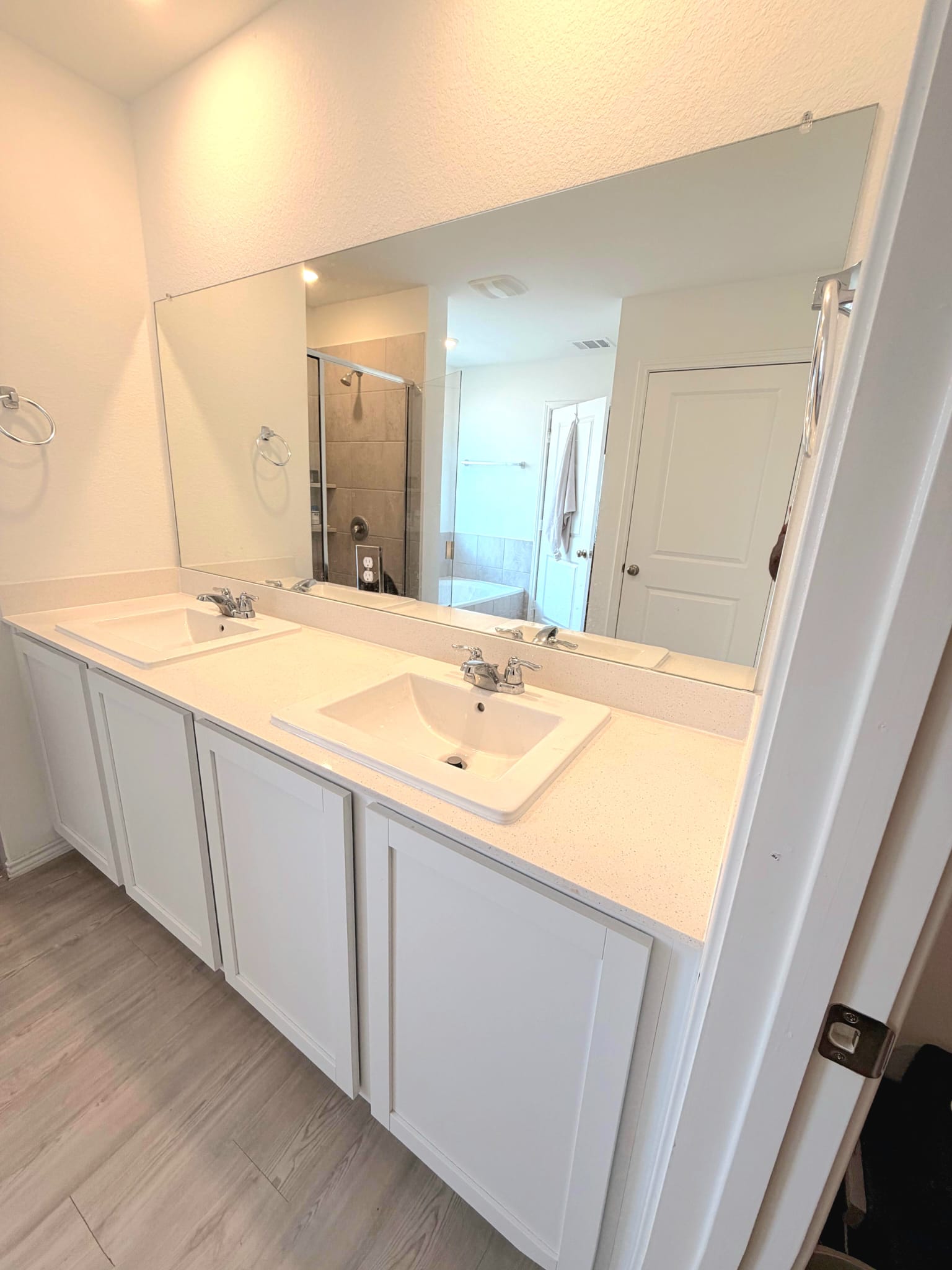 2520 Four Waters Loop Georgetown, TX 78628 - Photo 4 of 15 Bathroom with double vanity, a stall shower, and light wood-style floors