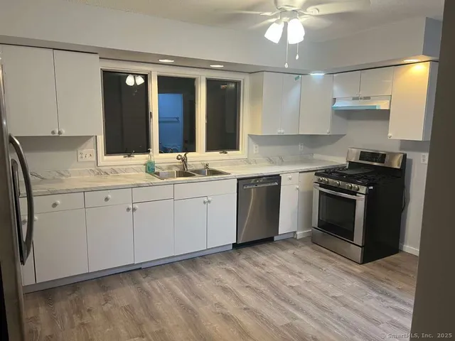 a kitchen with a stove oven and sink