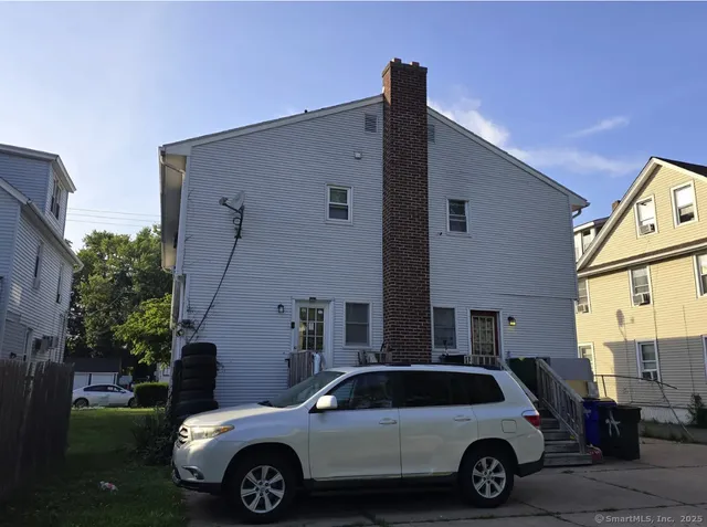 a view of a car parked in front of a house