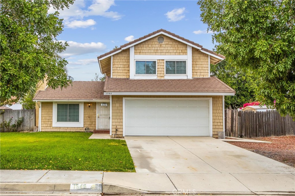 1546 West Jackson Street Rialto, CA 92376 - Photo 1 of 1 a front view of a house with a yard and garage