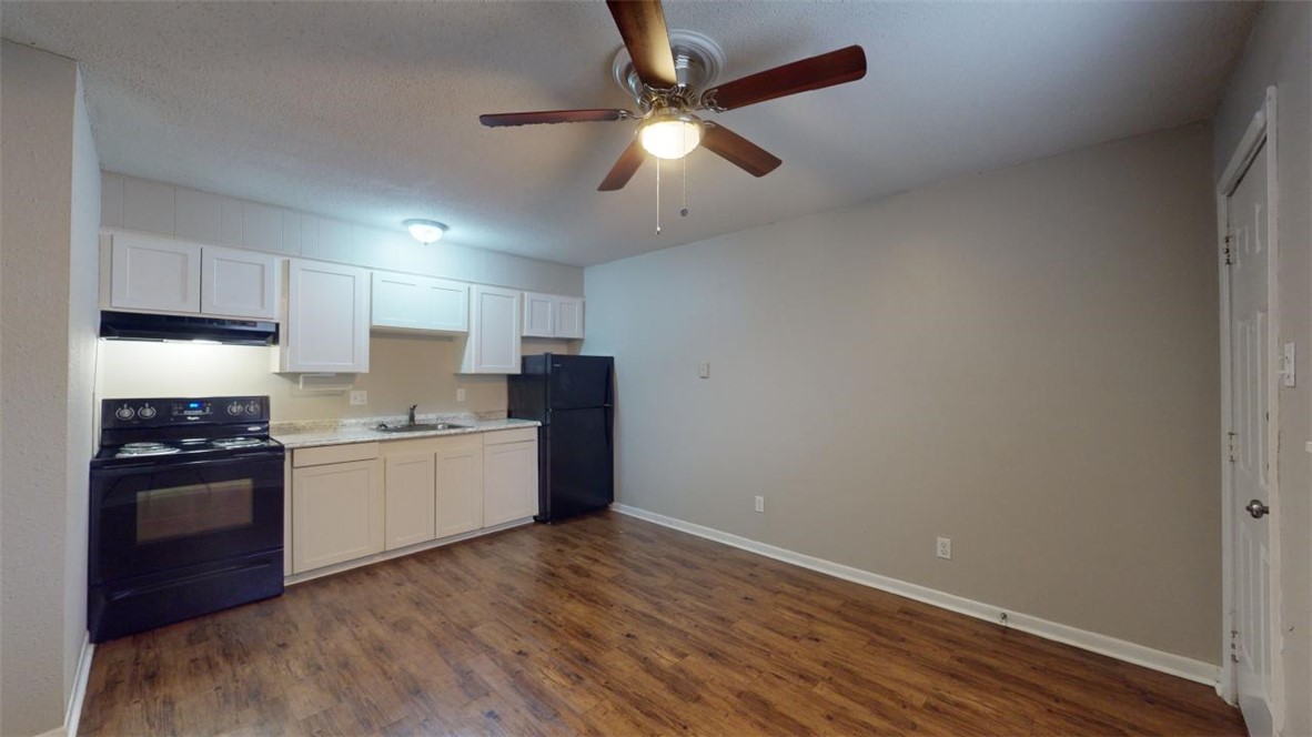 500 Foch Street, Unit 11 Bryan, TX 77801 - Photo 4 of 11 a kitchen with stainless steel appliances granite countertop a stove and a refrigerator