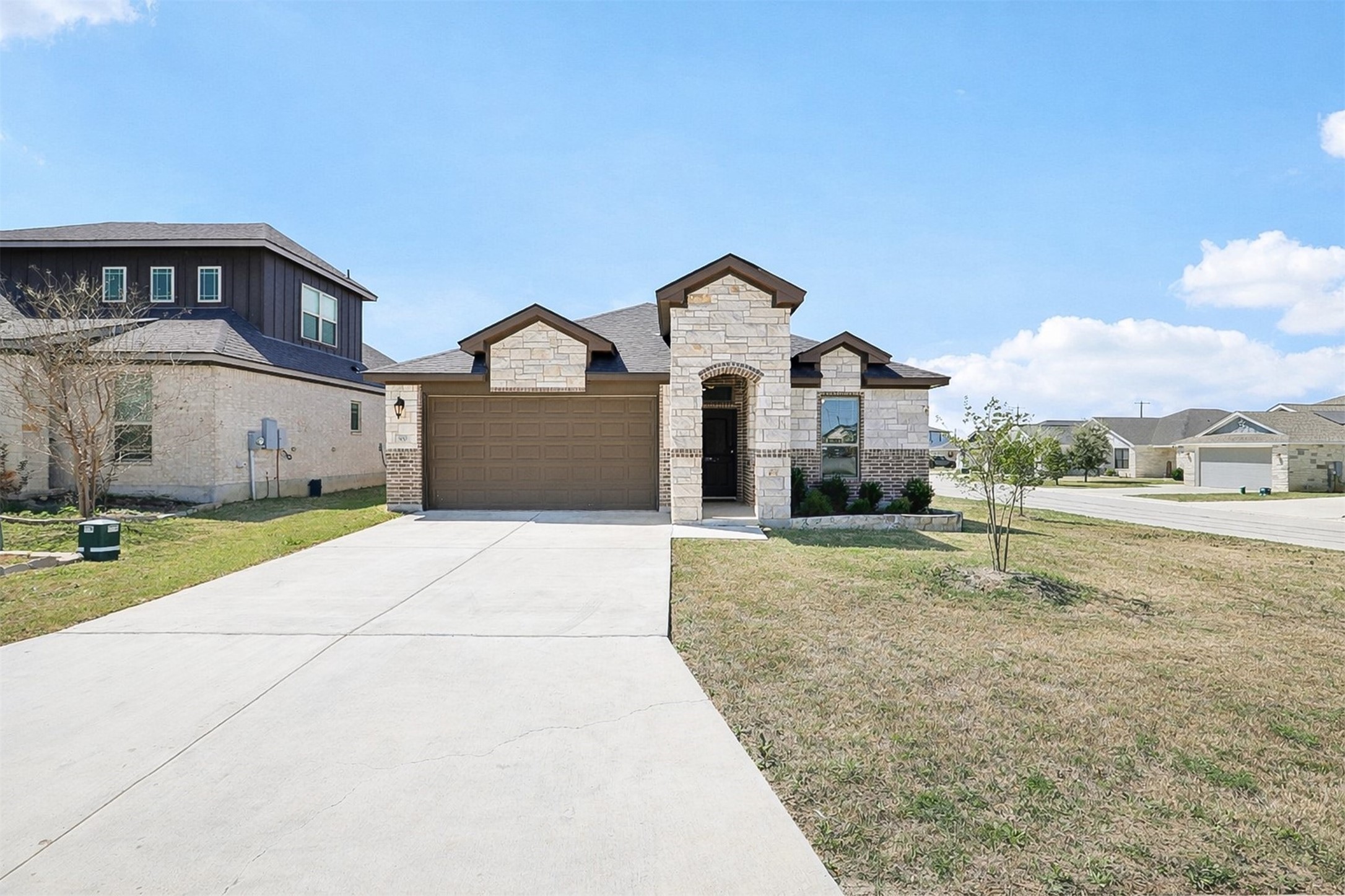 a front view of a house with a yard and garage