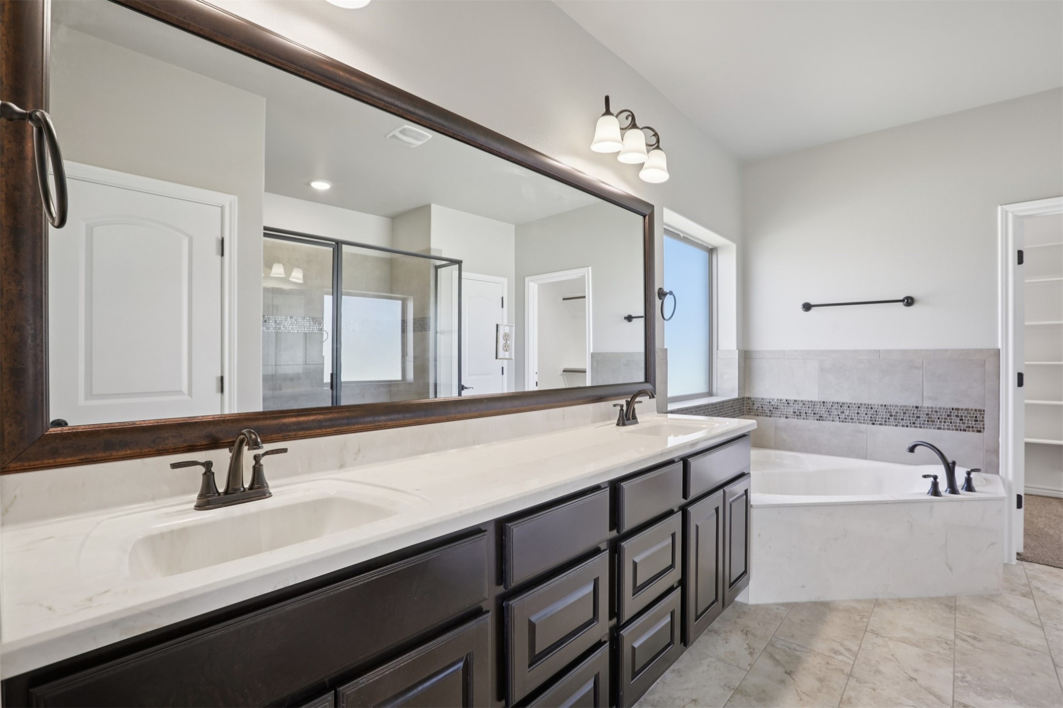 500 Seabiscuit Drive Jarrell, TX 76537 - Photo 17 of 33 a bathroom with a tub double sink and mirror