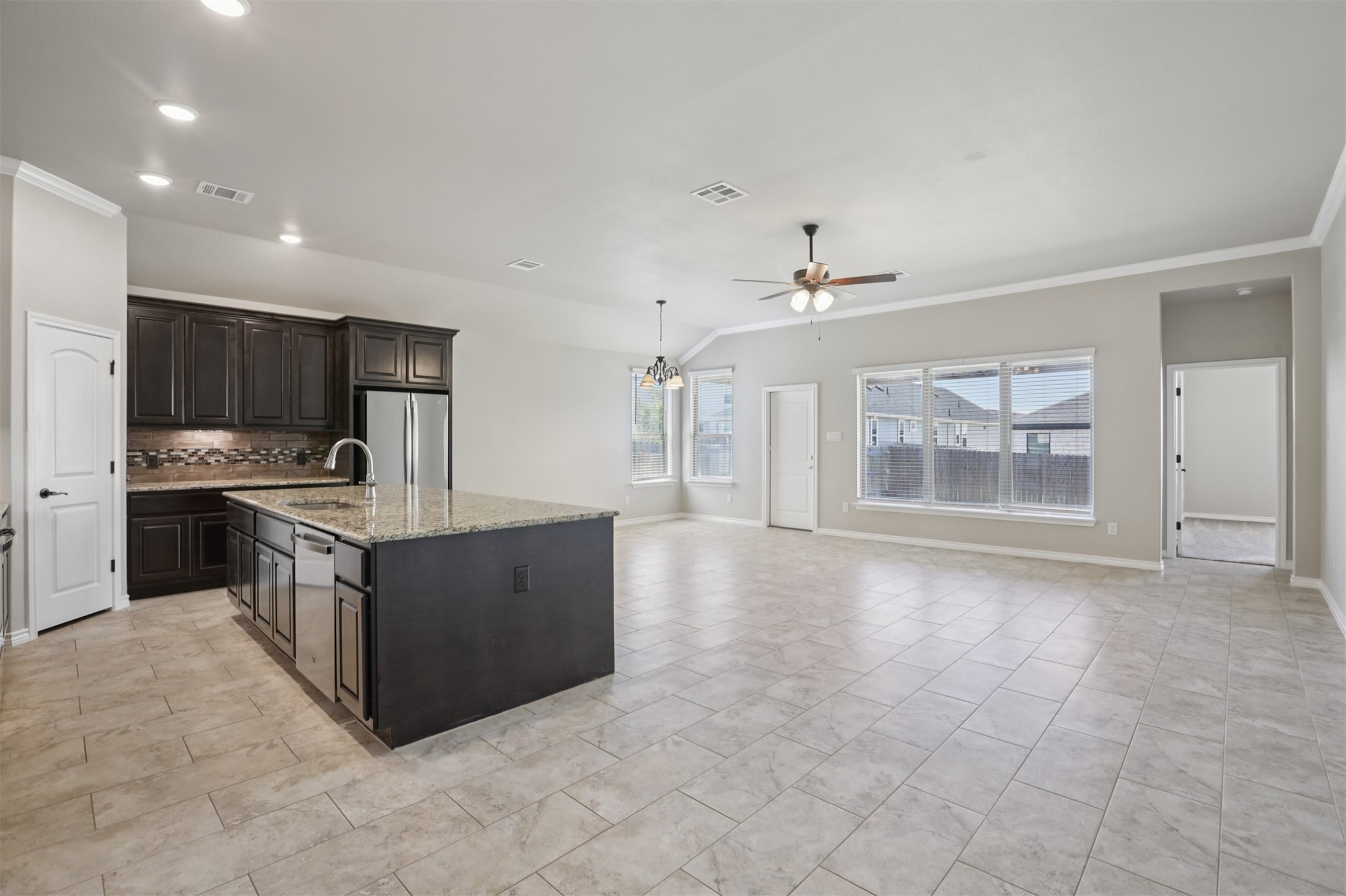 500 Seabiscuit Drive Jarrell, TX 76537 - Photo 8 of 33 a large kitchen with stainless steel appliances granite countertop a stove and a sink