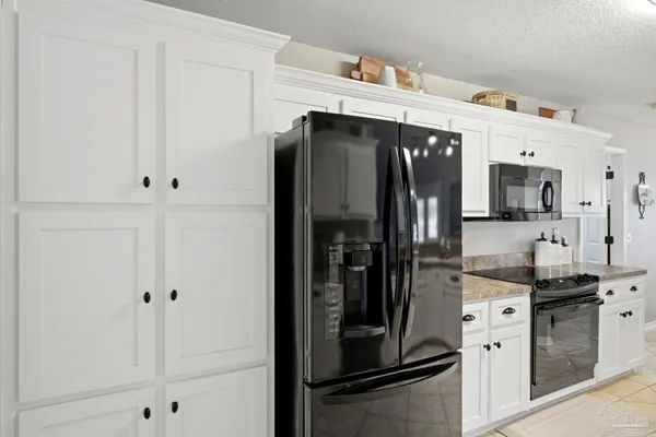 a kitchen with stainless steel appliances a refrigerator and cabinets