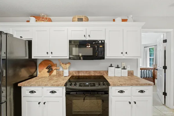 a white stove top oven sitting inside of a kitchen