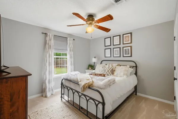 a bedroom with a bed and window