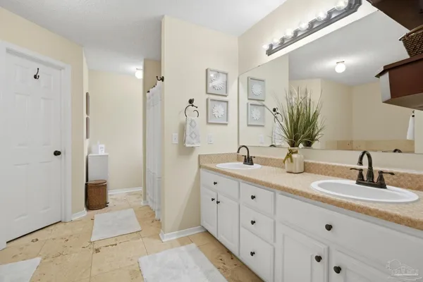 a bathroom with a double vanity sink and mirror