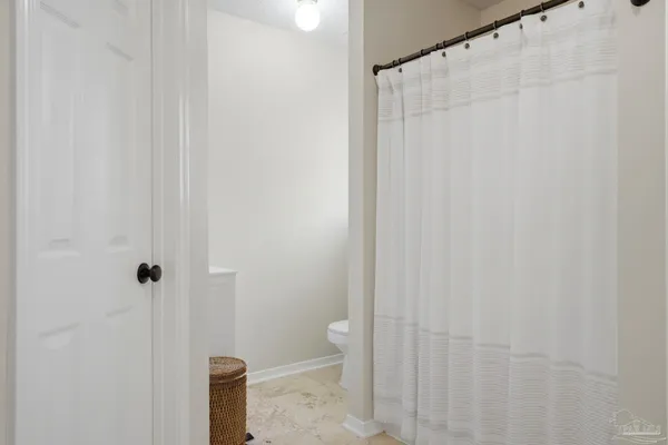 a bathroom with a shower and a toilet