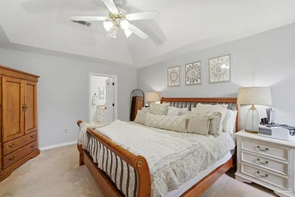 a living room with patio furniture and a floor to ceiling window