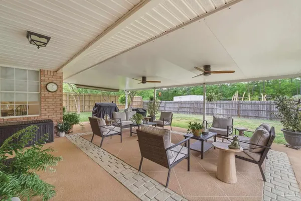 a view of a patio with couches chairs and a table