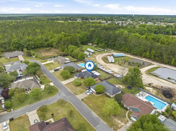 an aerial view of residential houses with outdoor space and swimming pool
