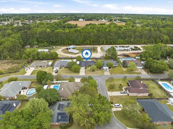 an aerial view of residential houses with outdoor space and street view