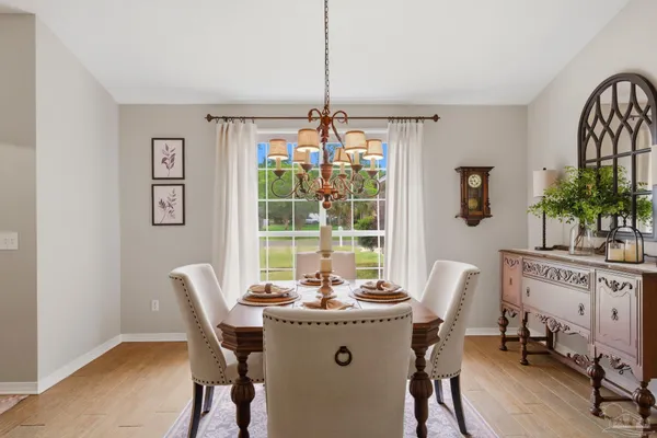a dining room with furniture a window and a chandelier