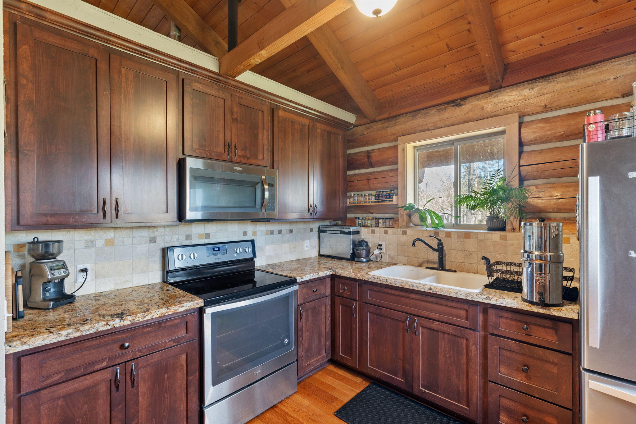 5737 Rockydale Road Cave Junction, OR 97523 - Photo 6 of 39 a kitchen with granite countertop stainless steel appliances a sink window and cabinets