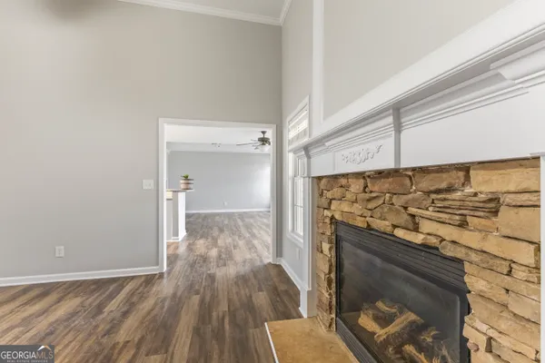 a view of a kitchen with wooden floor and a fireplace