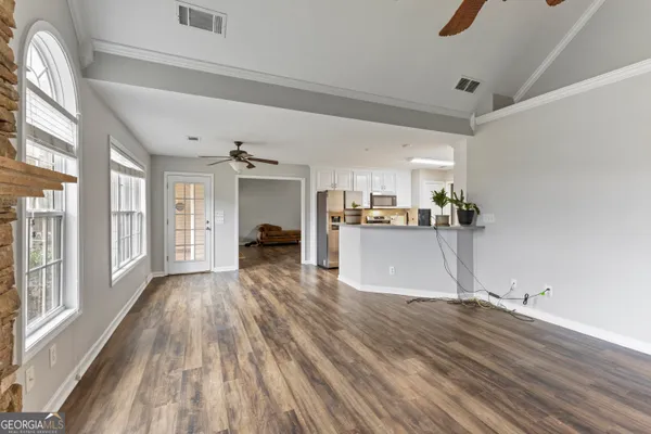 a view of a kitchen with wooden floor and a kitchen