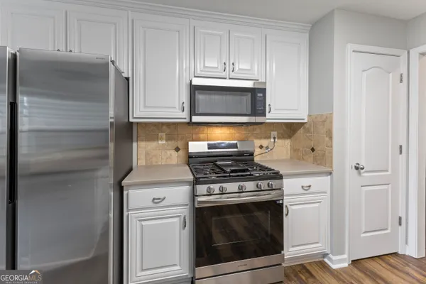 a kitchen with cabinets and steel stainless steel appliances