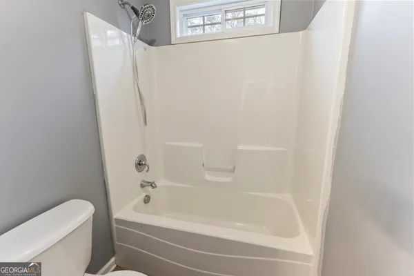 a bathroom with a bathtub and a toilet