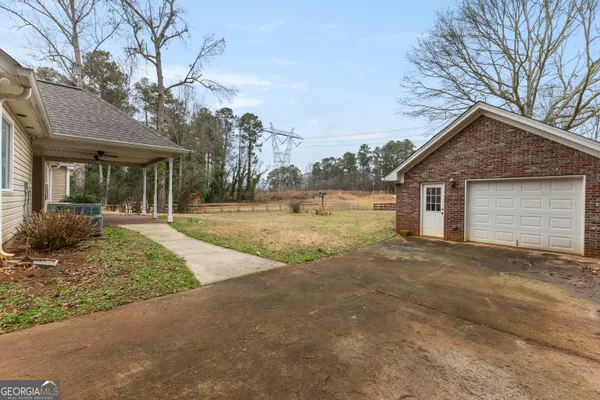 a view of a house with a yard and garage