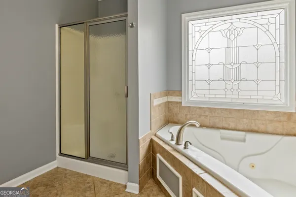 a bathroom with a tub and a window