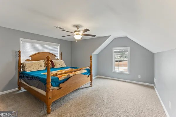 a bedroom with furniture and a window