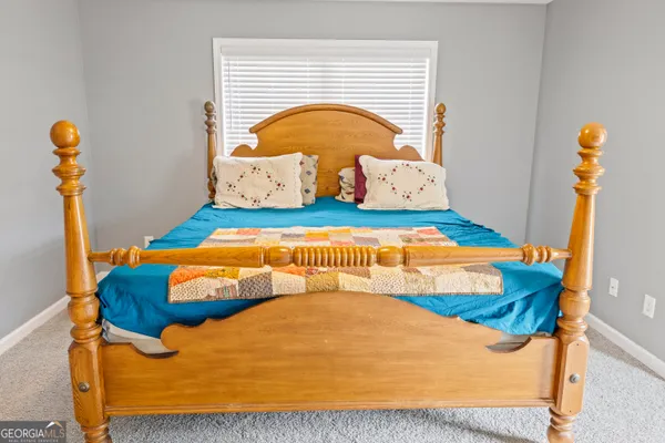 a bedroom with a bed and window