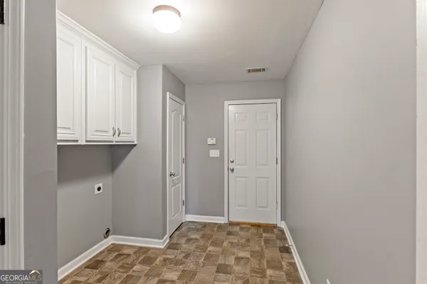 a view of hallway with wooden floor
