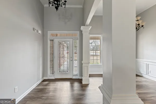 a view of an entryway with wooden floor