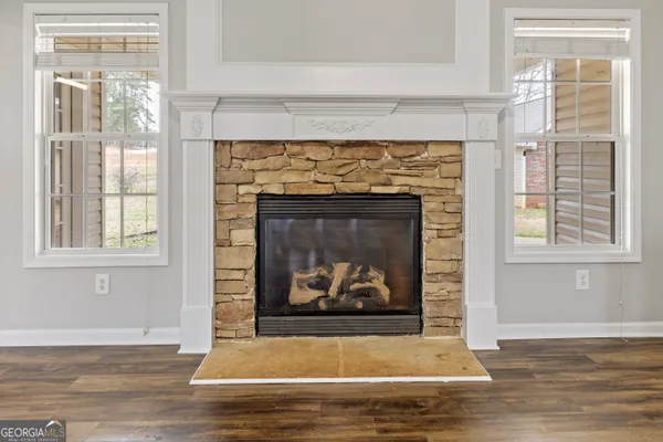 a view of fireplace with wooden floor